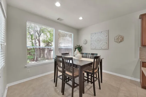 a view of a dining room with furniture and a window
