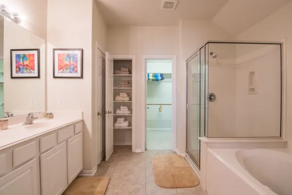 a bathroom with a tub sink and shower