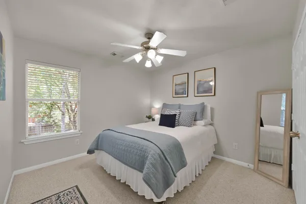 a bedroom with a bed and a window