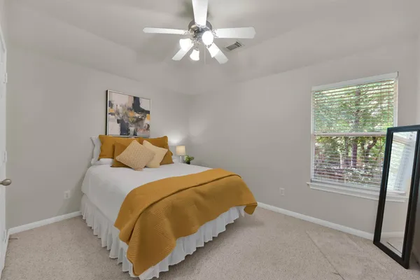 a bedroom with a bed and a window