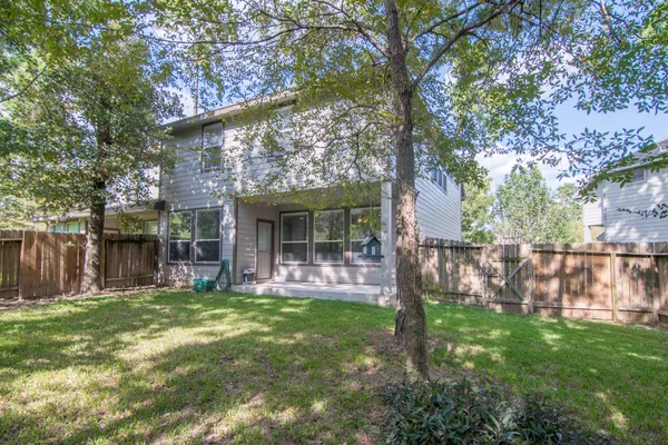 a view of a house with backyard and sitting area