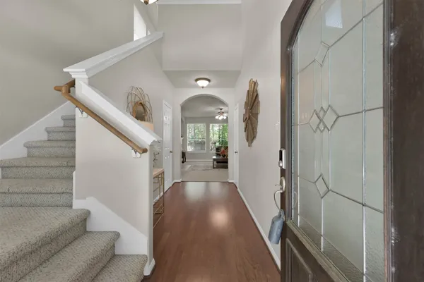 a view of entryway and hall with wooden floor