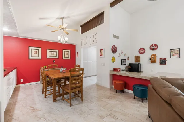 a dining room with a wooden table and chairs