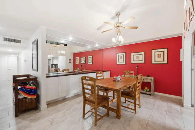 a spacious bedroom with a bed and a dresser