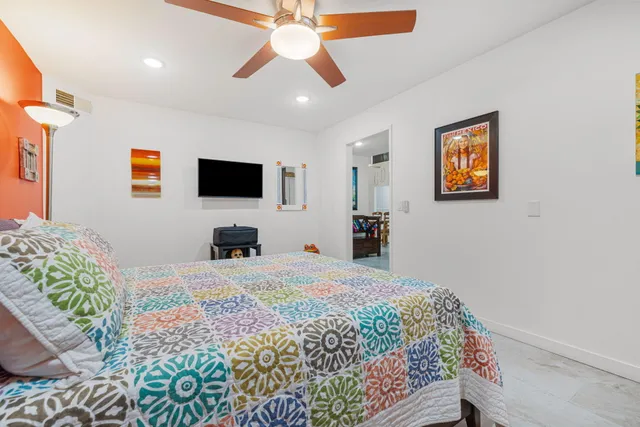 a bed room with a bed and a chandelier