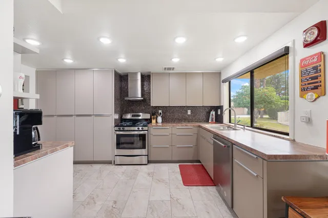 a kitchen with a sink stainless steel appliances and cabinets