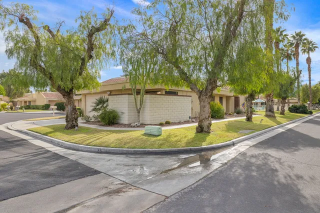 a view of a pathway both side of the house