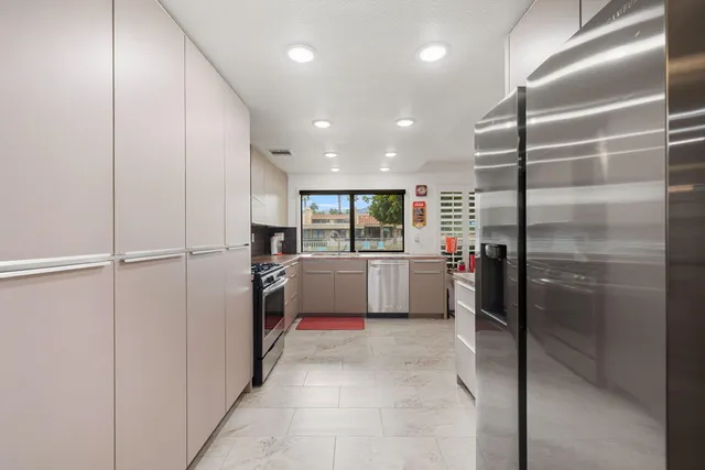 a kitchen with refrigerator and cabinets