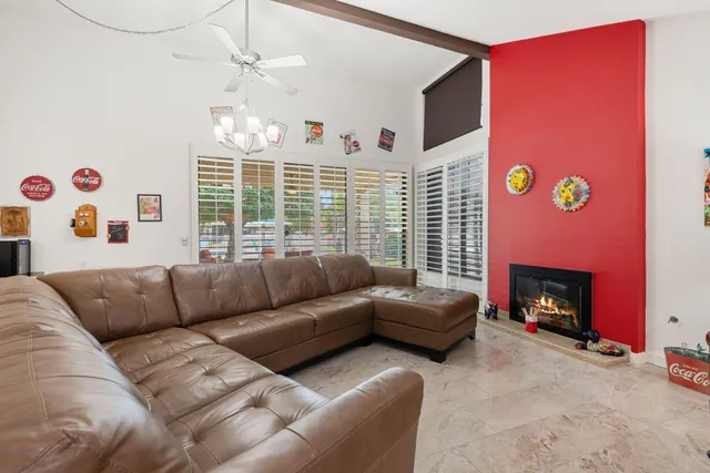 a living room with furniture window and fireplace