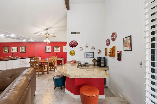 a view of a dining room with furniture and chandelier