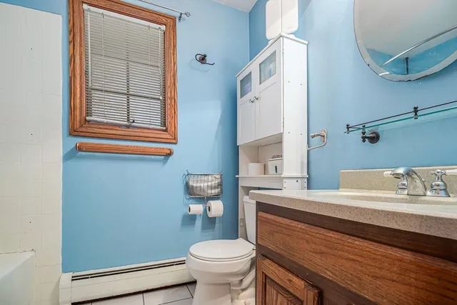 a bathroom with a sink a toilet and a mirror