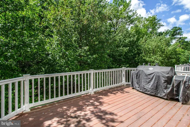 a view of balcony with wooden floor and fence