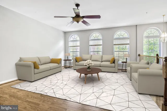 a living room with furniture a large window and a chandelier