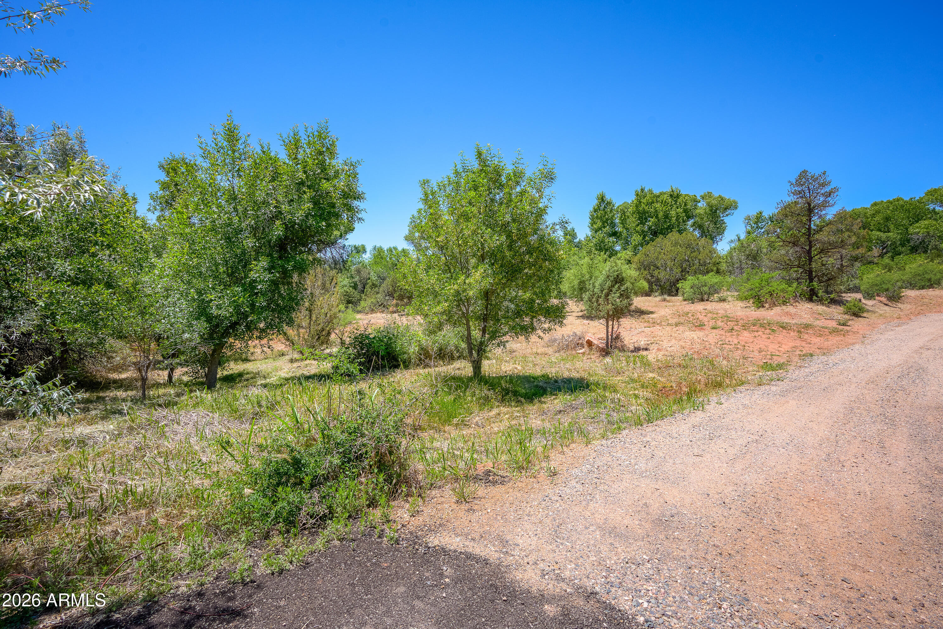 3155 Red Rock Loop Road, Unit 1 Sedona, AZ 86336 - Photo 11 of 18 a backyard of a house with a yard and outdoor seating