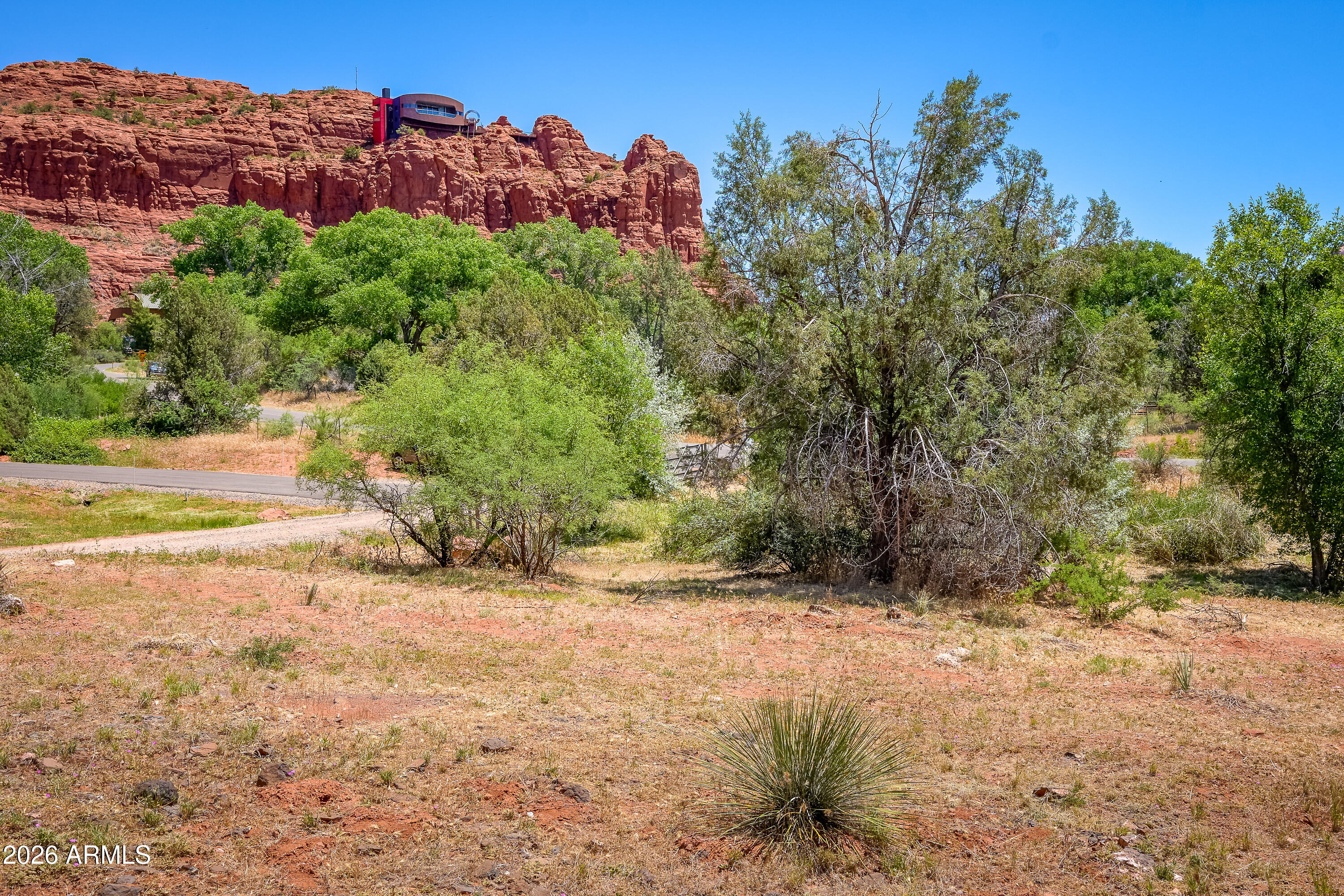 3155 Red Rock Loop Road, Unit 1 Sedona, AZ 86336 - Photo 15 of 18 a view of a yard with a tree