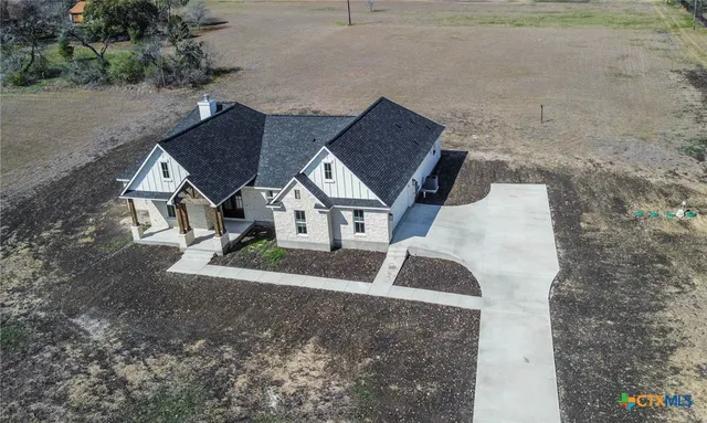 an aerial view of a house with a yard
