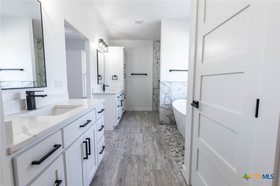 110 Lake Village Road Seguin, TX 78155 - Photo 22 of 38 a bathroom with a sink a toilet and shower