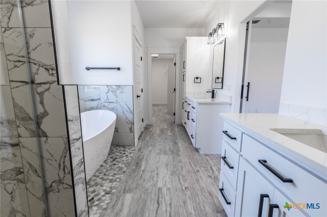 110 Lake Village Road Seguin, TX 78155 - Photo 23 of 38 a bathroom with a granite countertop sink toilet and shower