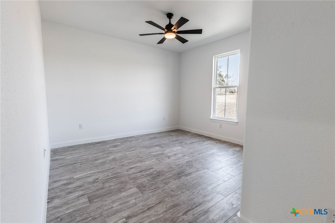 110 Lake Village Road Seguin, TX 78155 - Photo 27 of 38 wooden floor in an empty room with a window