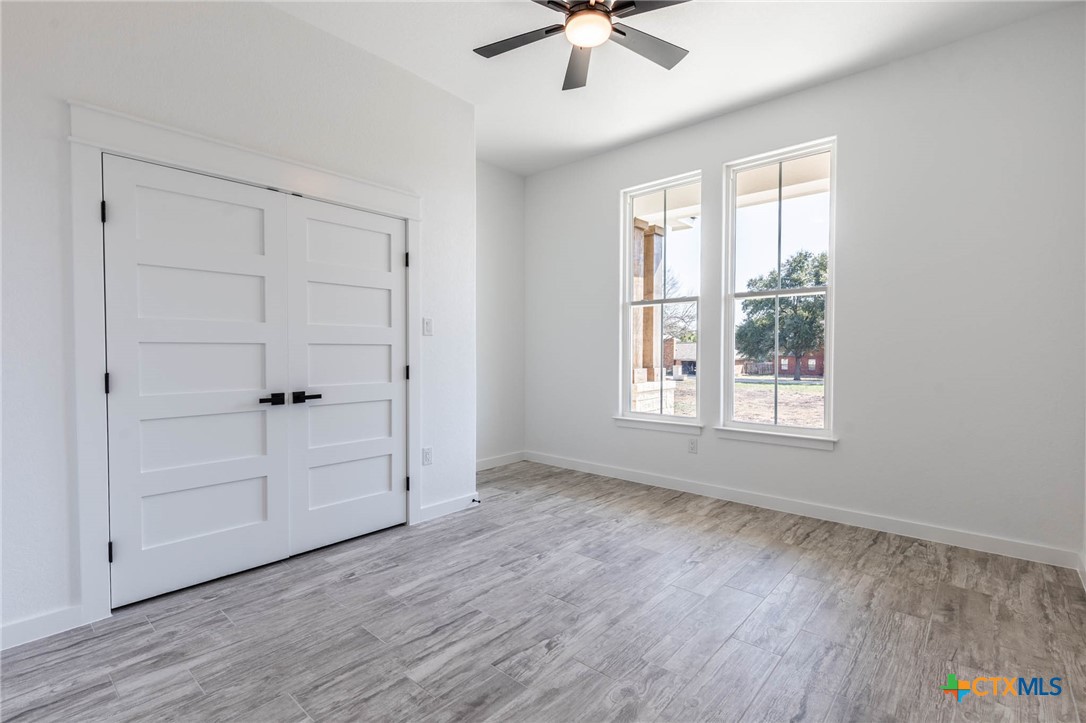 110 Lake Village Road Seguin, TX 78155 - Photo 30 of 38 wooden floor in an empty room with a window
