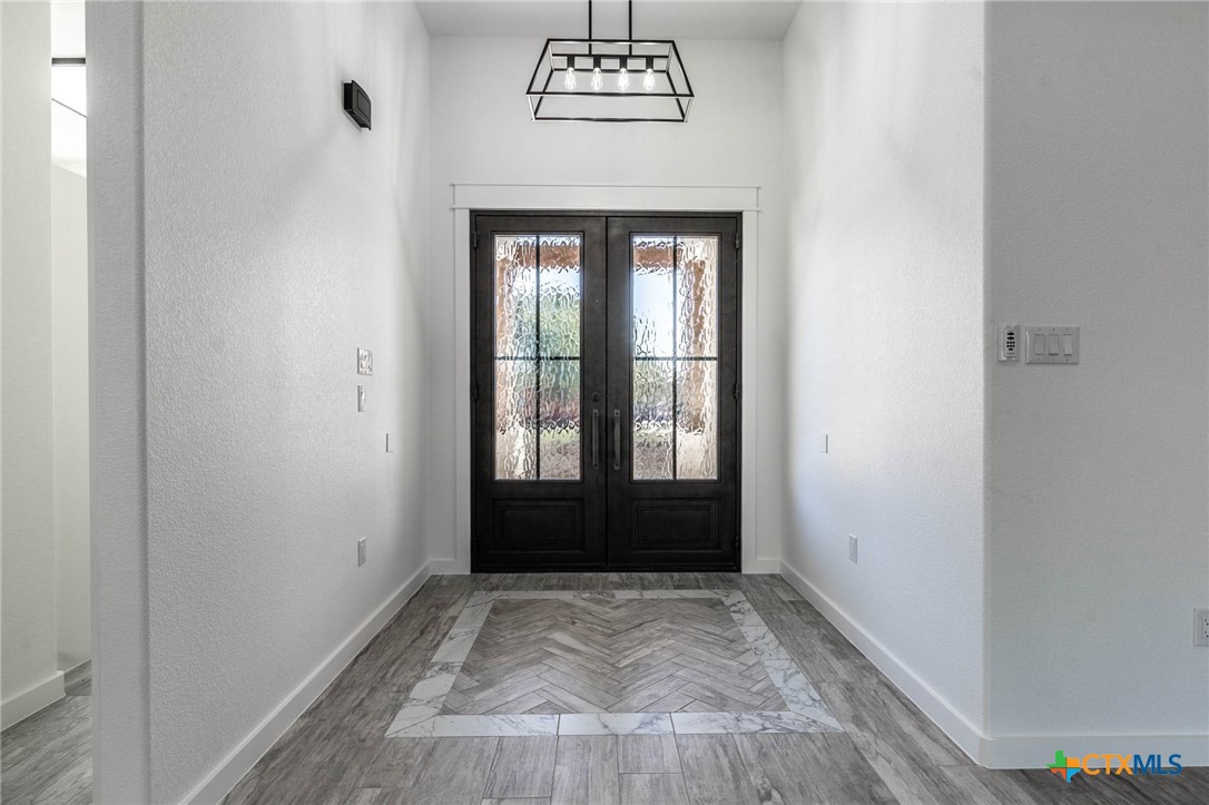 110 Lake Village Road Seguin, TX 78155 - Photo 7 of 38 wooden floor in an empty room with a window