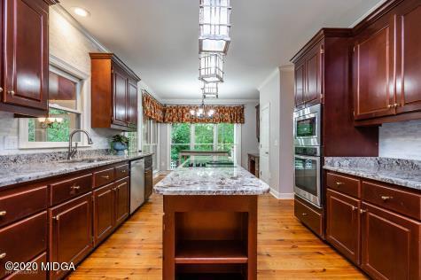 113 Hampton Ridge Road Macon, GA 31220 - Photo 11 of 29 a kitchen with stainless steel appliances granite countertop wooden cabinets and a refrigerator