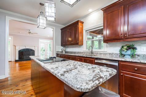 113 Hampton Ridge Road Macon, GA 31220 - Photo 15 of 29 a kitchen with kitchen island granite countertop wooden cabinets a sink and a stove
