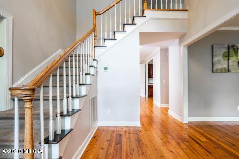 113 Hampton Ridge Road Macon, GA 31220 - Photo 3 of 29 a view of staircase with wooden floor and a rug