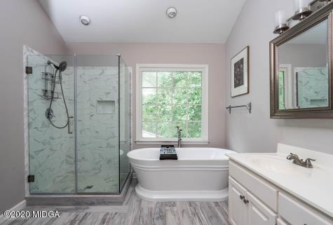 113 Hampton Ridge Road Macon, GA 31220 - Photo 25 of 29 a bathroom with a tub sink toilet a mirror and next to a window