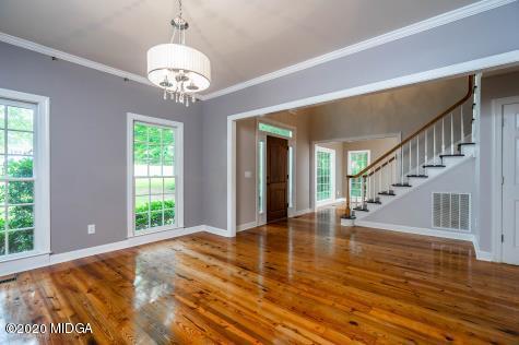 113 Hampton Ridge Road Macon, GA 31220 - Photo 4 of 29 a view of an empty room with wooden floor and a large window