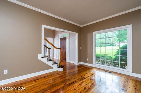 113 Hampton Ridge Road Macon, GA 31220 - Photo 6 of 29 a view of an empty room with wooden floor and a window