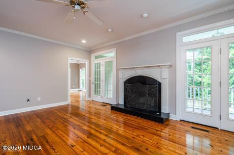 113 Hampton Ridge Road Macon, GA 31220 - Photo 9 of 29 a view of empty room with fireplace and fan