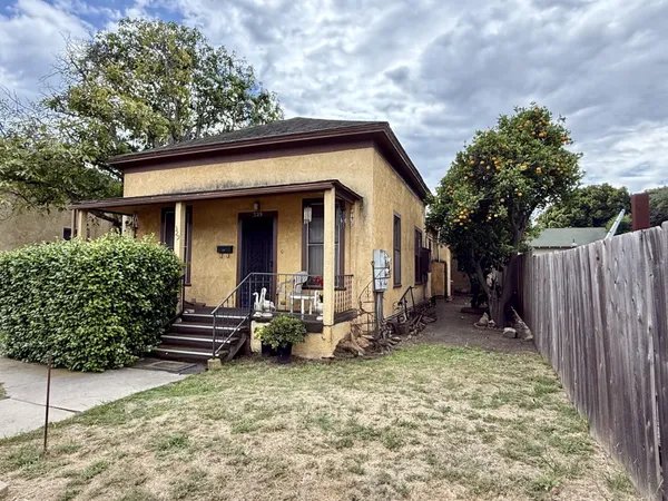 a front view of a house with garden