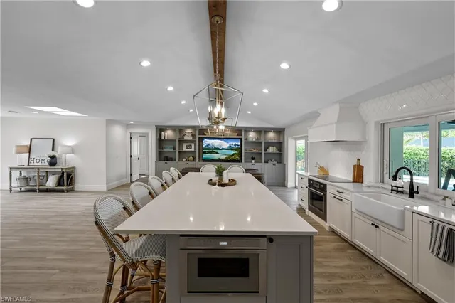 a living room with fireplace furniture and a large window