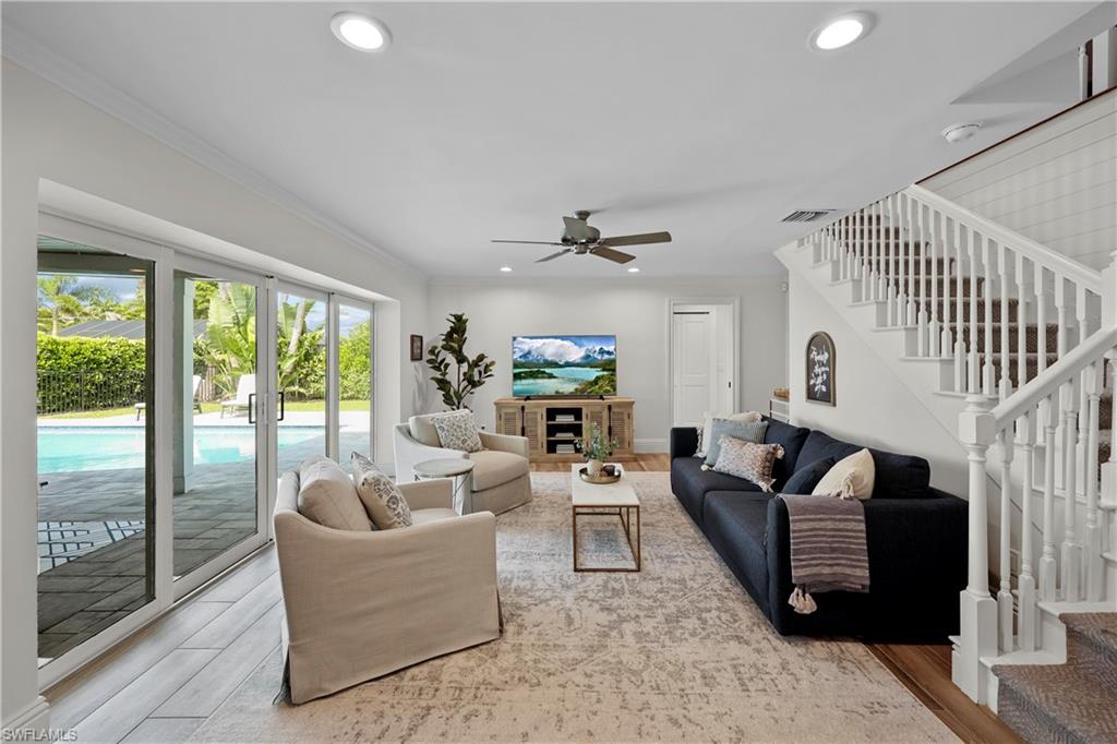 4611 Crayton Road Naples, FL 34103 - Photo 15 of 38 a living room with fireplace furniture and a large window