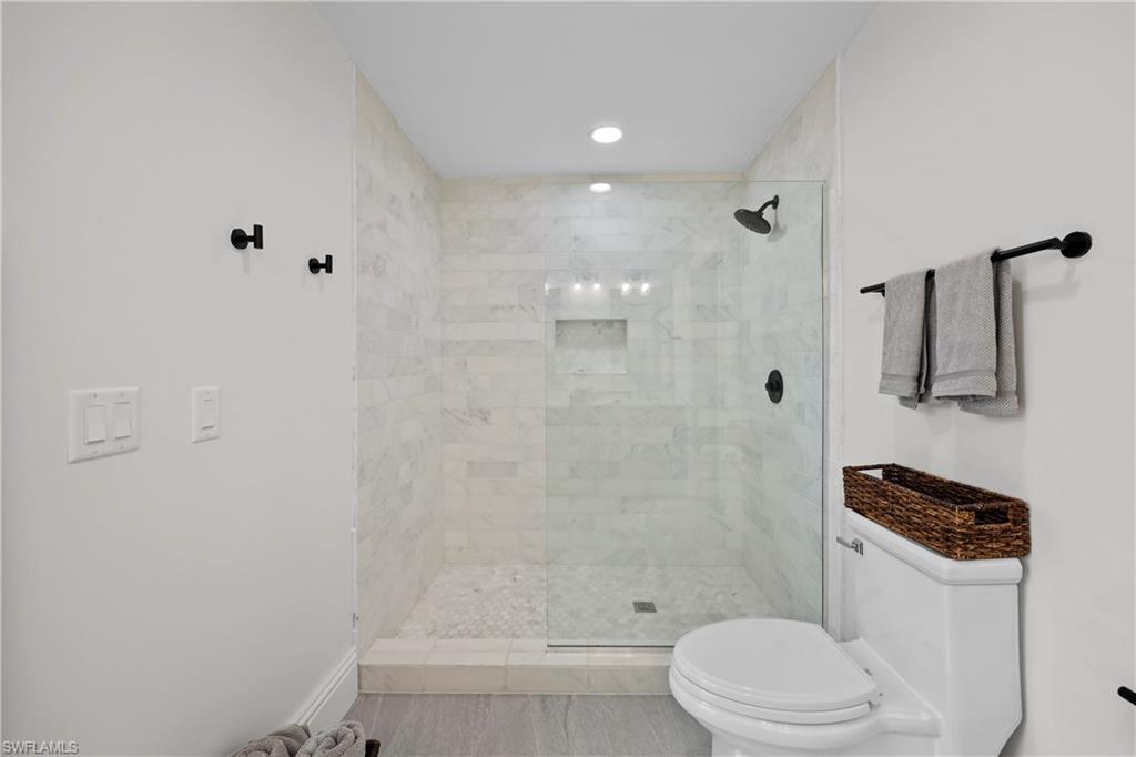 4611 Crayton Road Naples, FL 34103 - Photo 21 of 38 a bathroom with a toilet a sink and shower