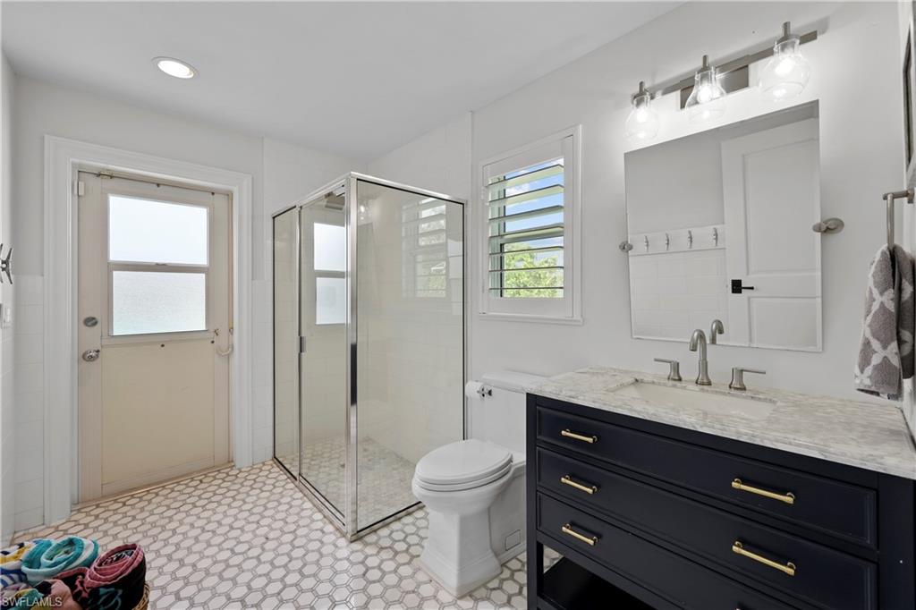 4611 Crayton Road Naples, FL 34103 - Photo 26 of 38 a bathroom with a sink a toilet and shower