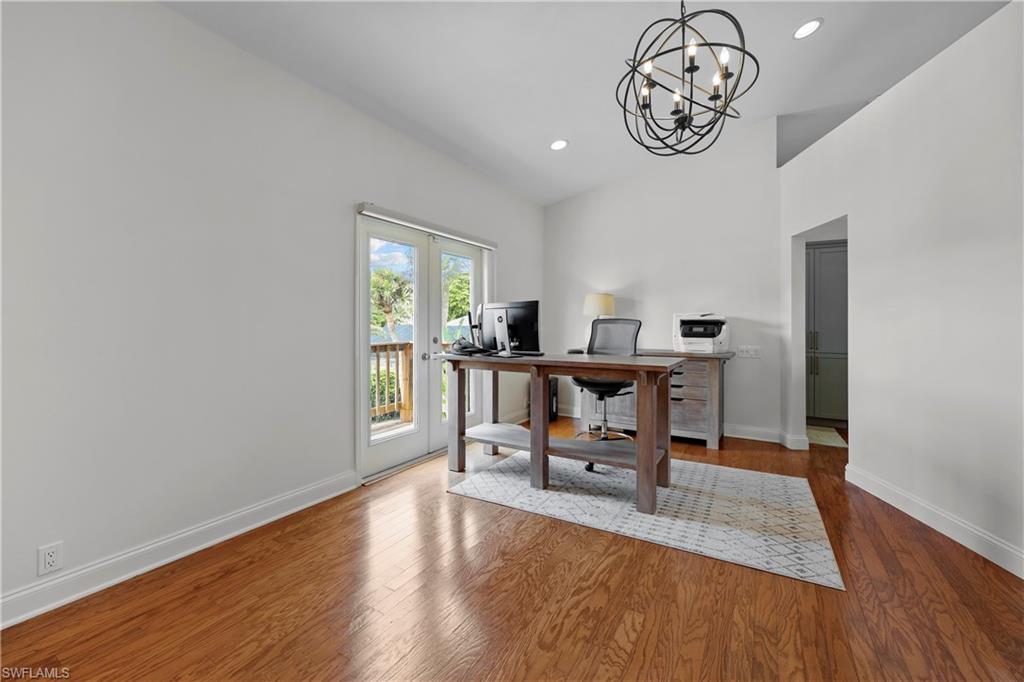 4611 Crayton Road Naples, FL 34103 - Photo 27 of 38 a view of a dining room with furniture wooden floor and a window