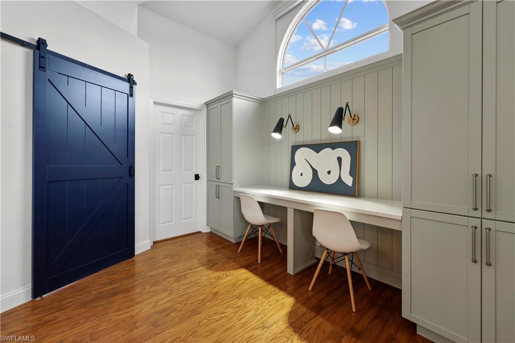 4611 Crayton Road Naples, FL 34103 - Photo 29 of 38 a bedroom with a bed and a table in it