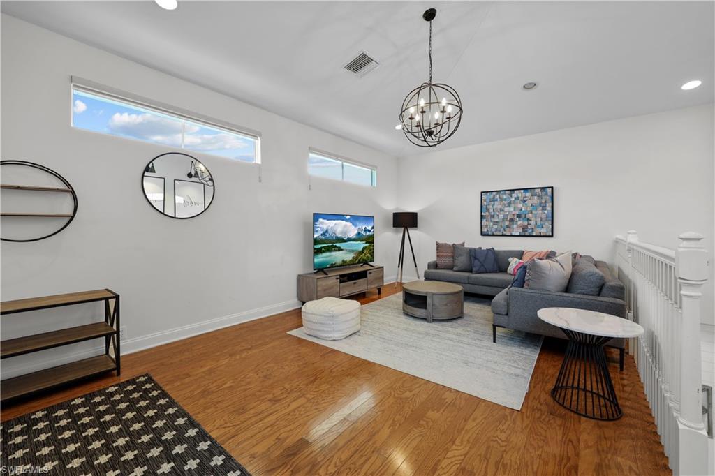 4611 Crayton Road Naples, FL 34103 - Photo 30 of 38 a living room with furniture a rug and a window
