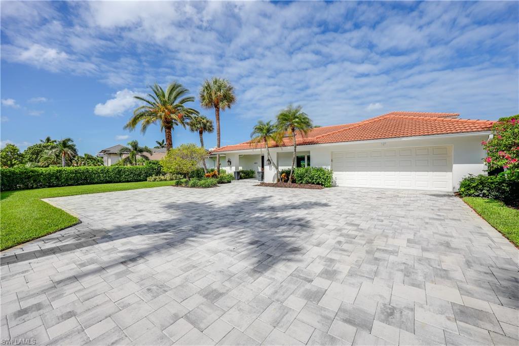 4611 Crayton Road Naples, FL 34103 - Photo 3 of 38 a front view of a house with a yard and garage
