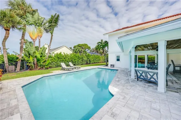 a view of a house with swimming pool and a yard