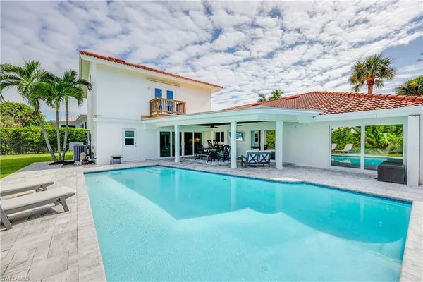 a view of house with swimming pool outdoor seating and barbeque oven