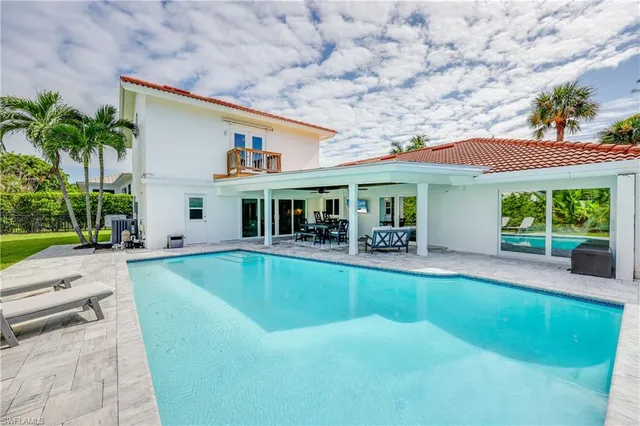 a view of house with swimming pool outdoor seating and barbeque oven