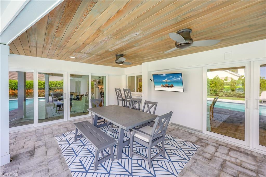 4611 Crayton Road Naples, FL 34103 - Photo 36 of 38 a living room with a large window