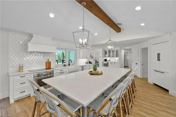 a kitchen with a table chairs and wooden floor