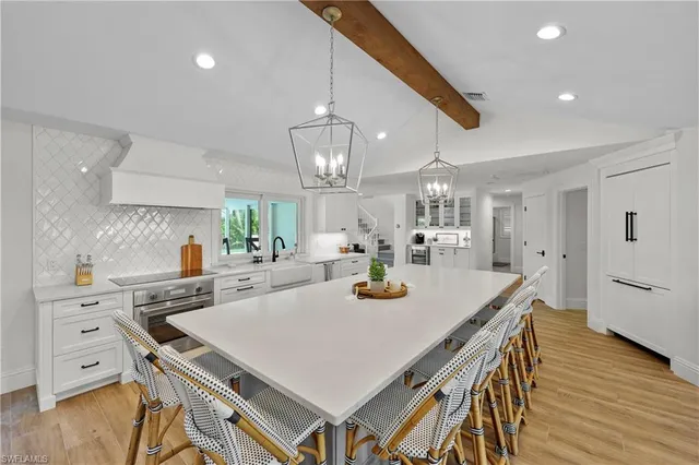 a kitchen with a table chairs and wooden floor