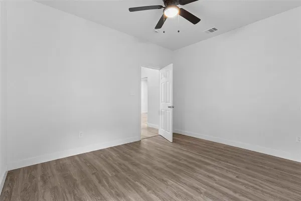 a bathroom with a toilet sink vanity and mirror