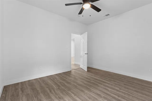 a bathroom with a toilet sink vanity and mirror