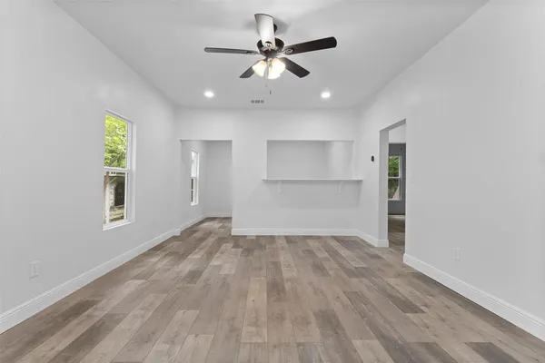 wooden floor in an empty room with a window